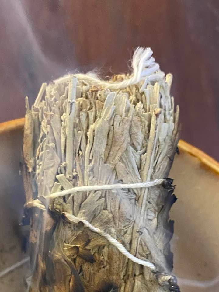 A close up of the top of a sage smudge stick.